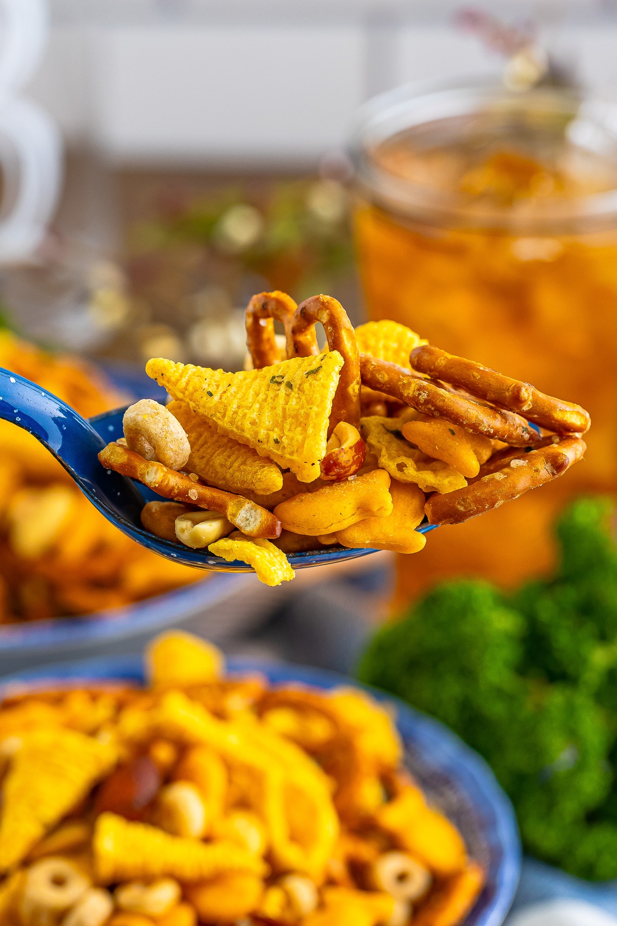 a spoon holding up a portion of Snack Mix in air