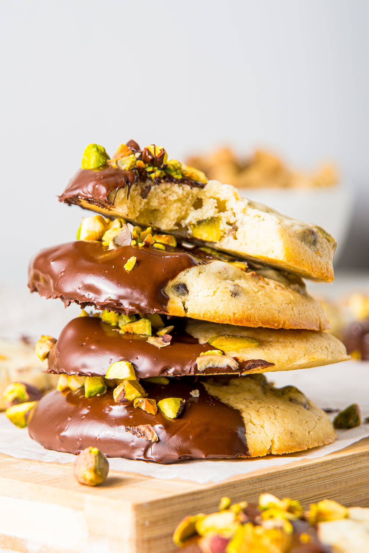 a stack of Pistachio Cookies the one of top has a bite taken out to show the interior
