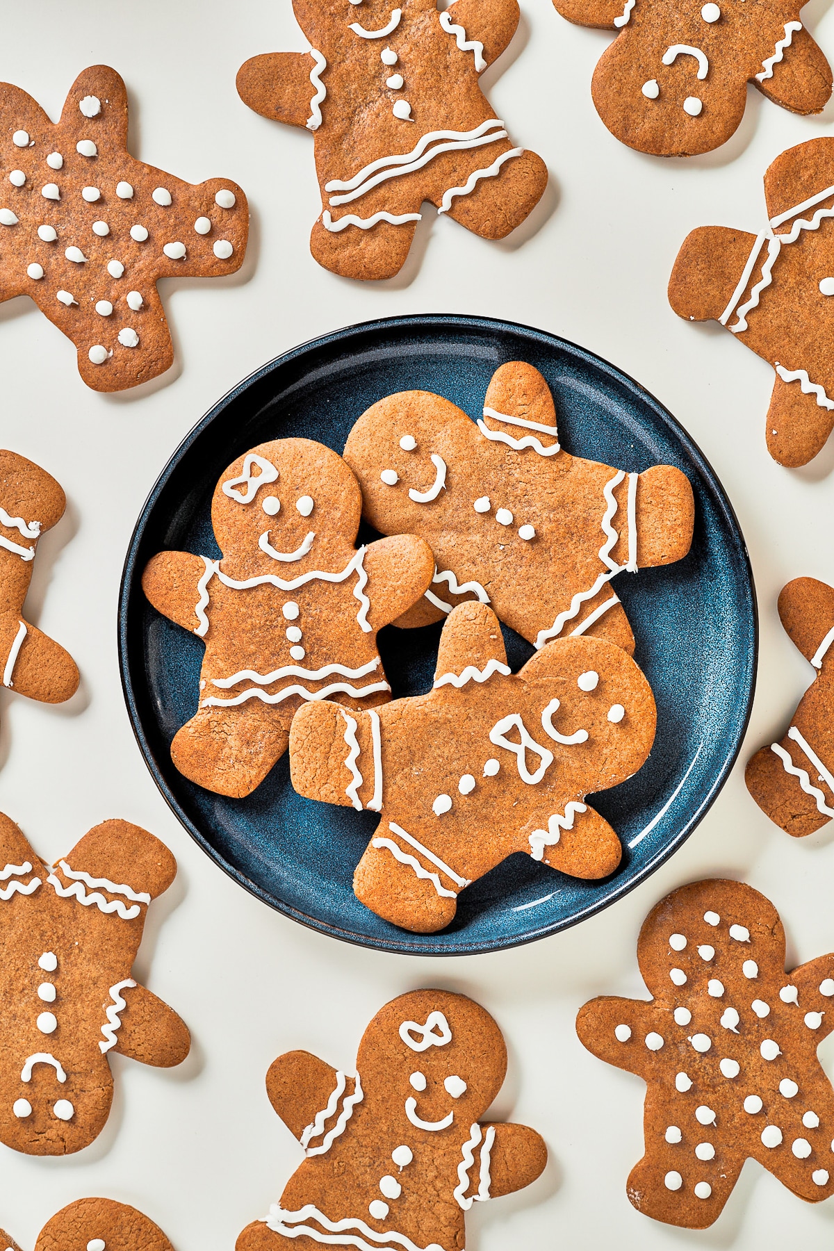 Gingerbread Men Recipe on a dark blue plate overhead image