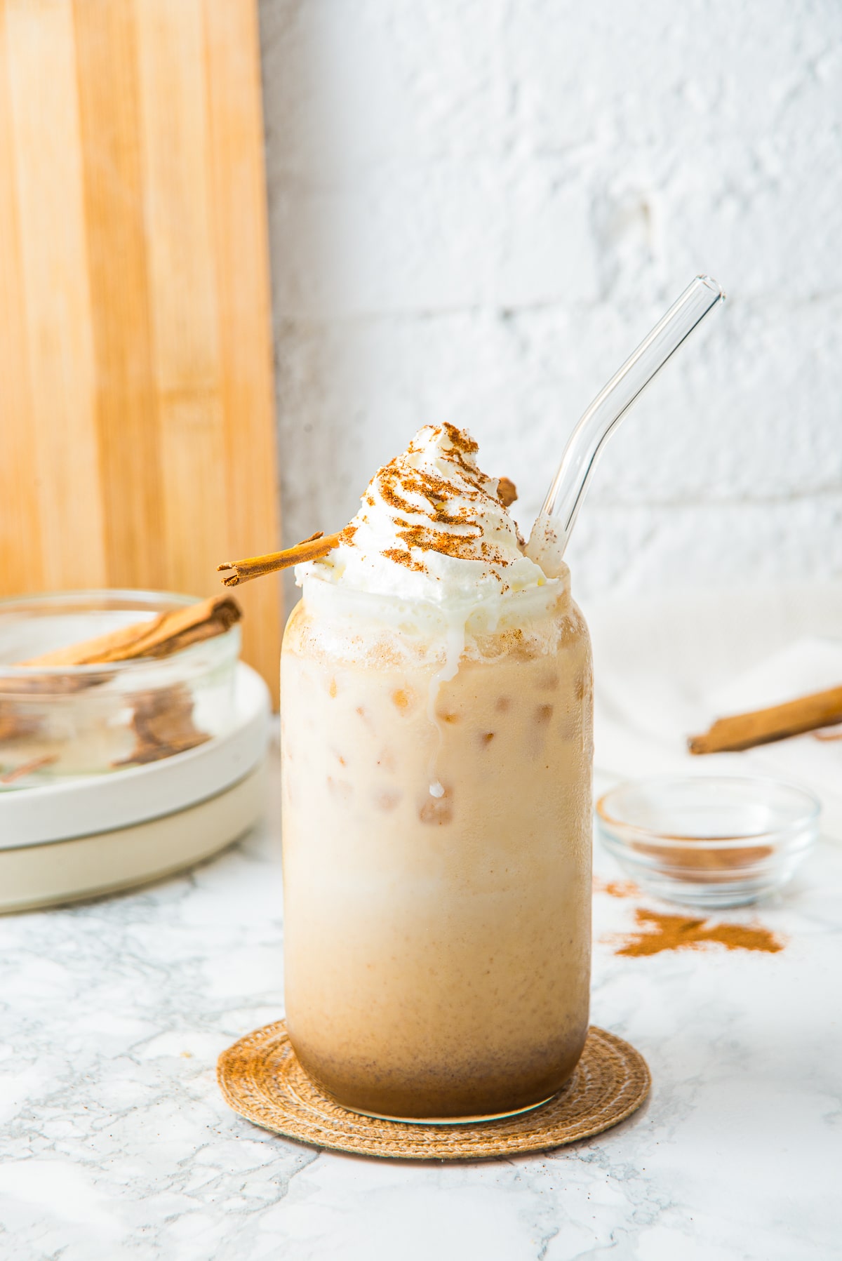Iced Pumpkin Spiced Latte in tall glass with garnishes