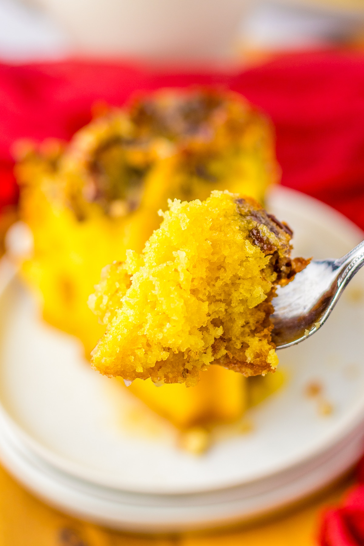 a bite of Rum Soaked Cake on a fork in air