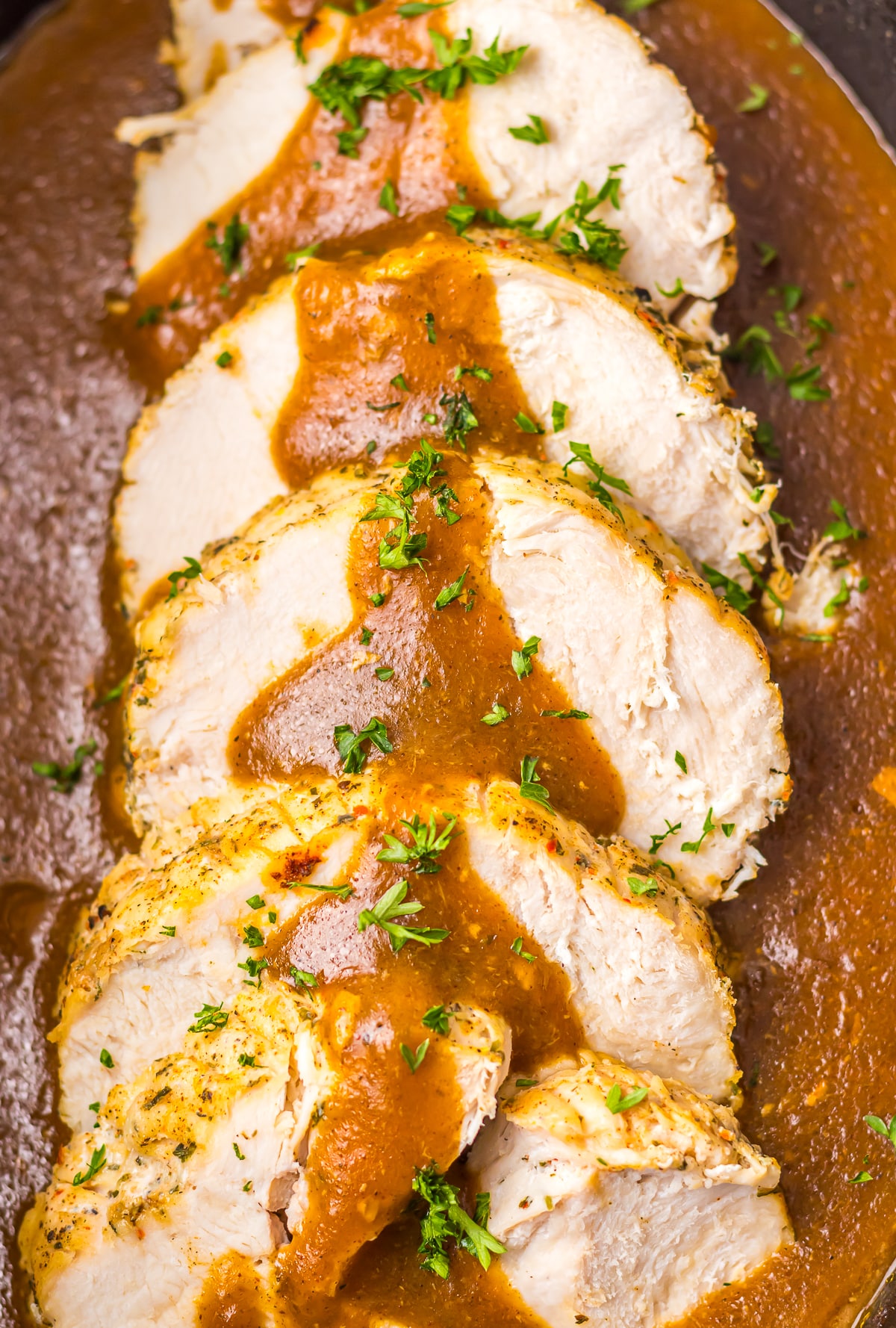sliced Slow Cooker Turkey Breast in slow cooker with gravy