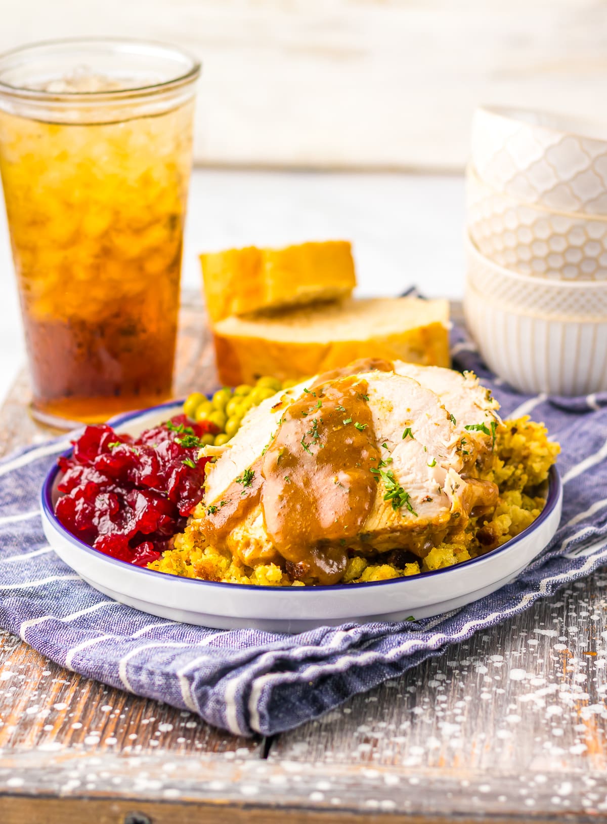 farther away image of Slow Cooker Turkey Breast served with side dishes