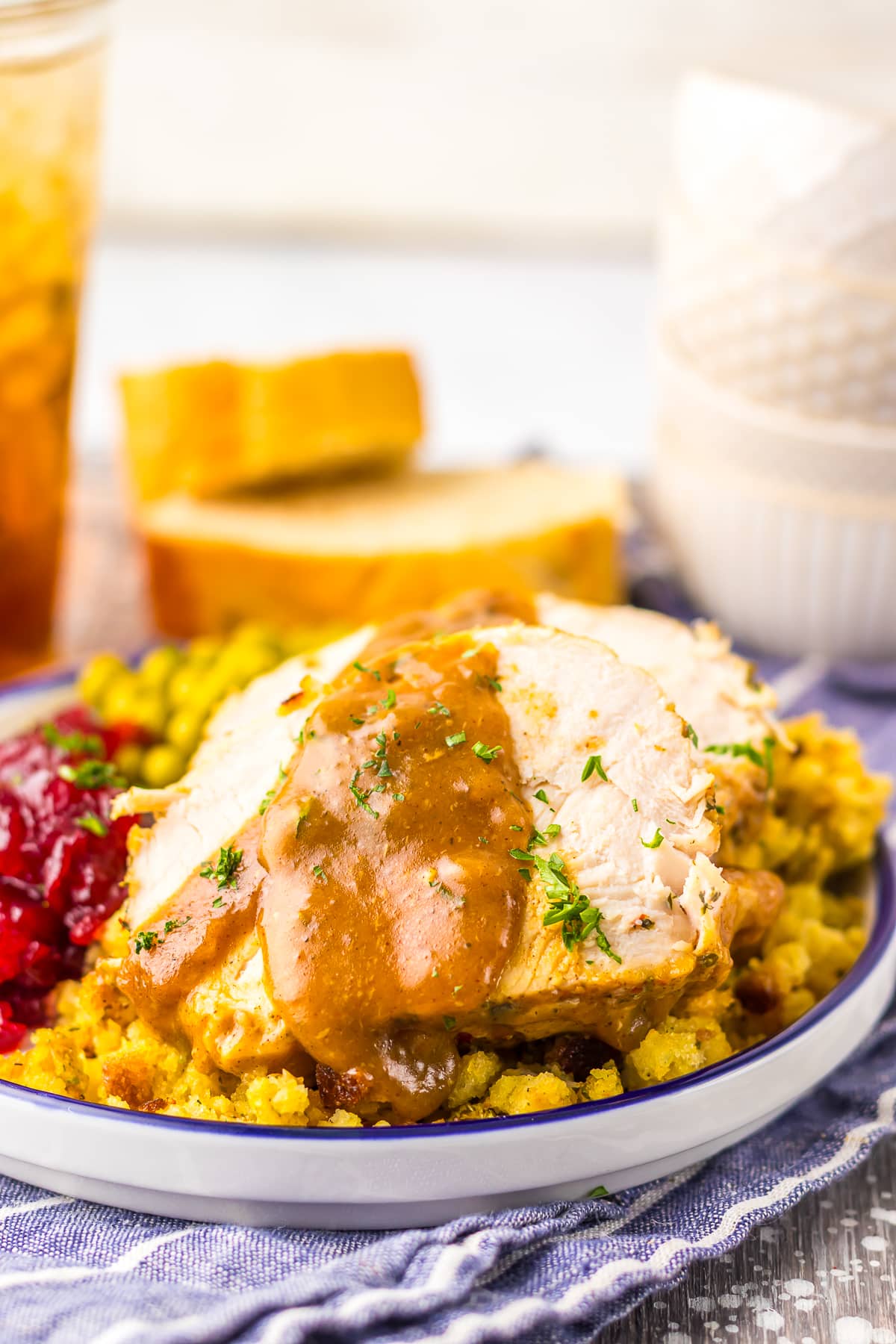 Slow Cooker Turkey Breast sliced with gravy on a white plate