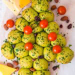 Christmas Tree Pull Apart Bread decorated with cherry tomato ornaments and a cheese star.