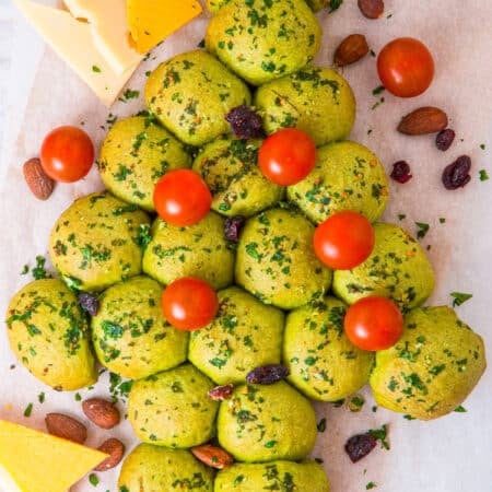 Christmas Tree Pull Apart Bread decorated with cherry tomato ornaments and a cheese star.