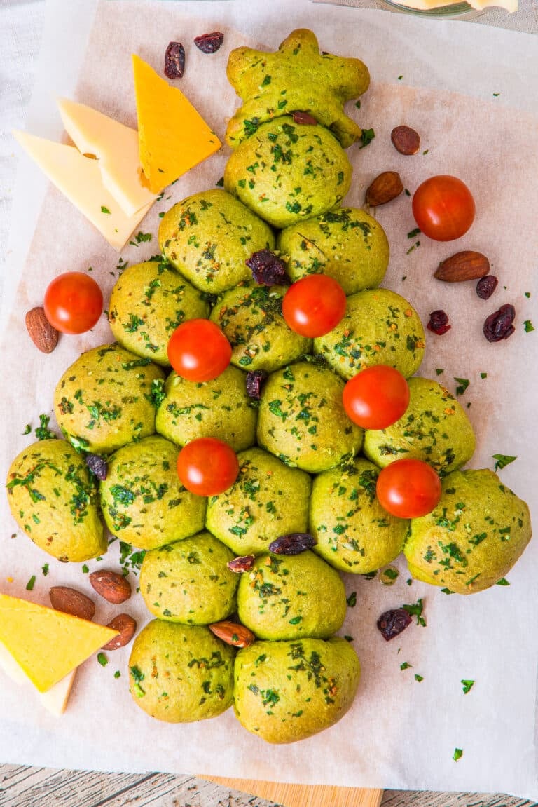 Christmas Tree Pull Apart Bread decorated with cherry tomato ornaments and a cheese star.