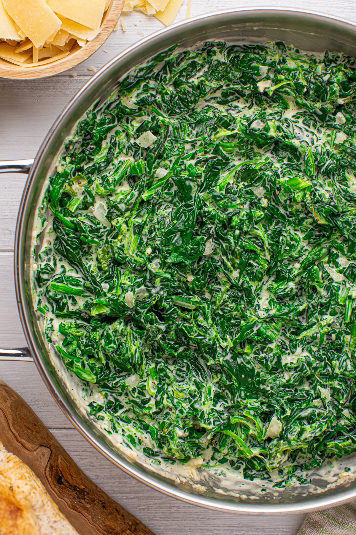 up close overhead image of Creamed Spinach in silver pan