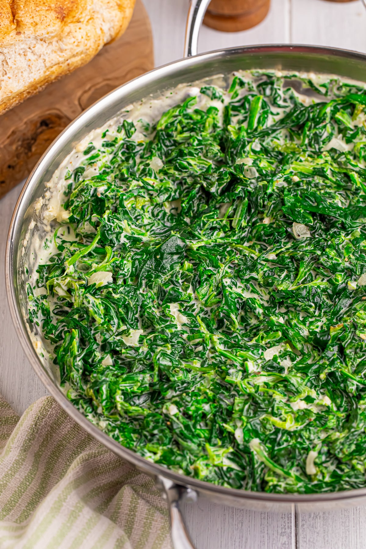 Creamed Spinach in a skillet on white table top