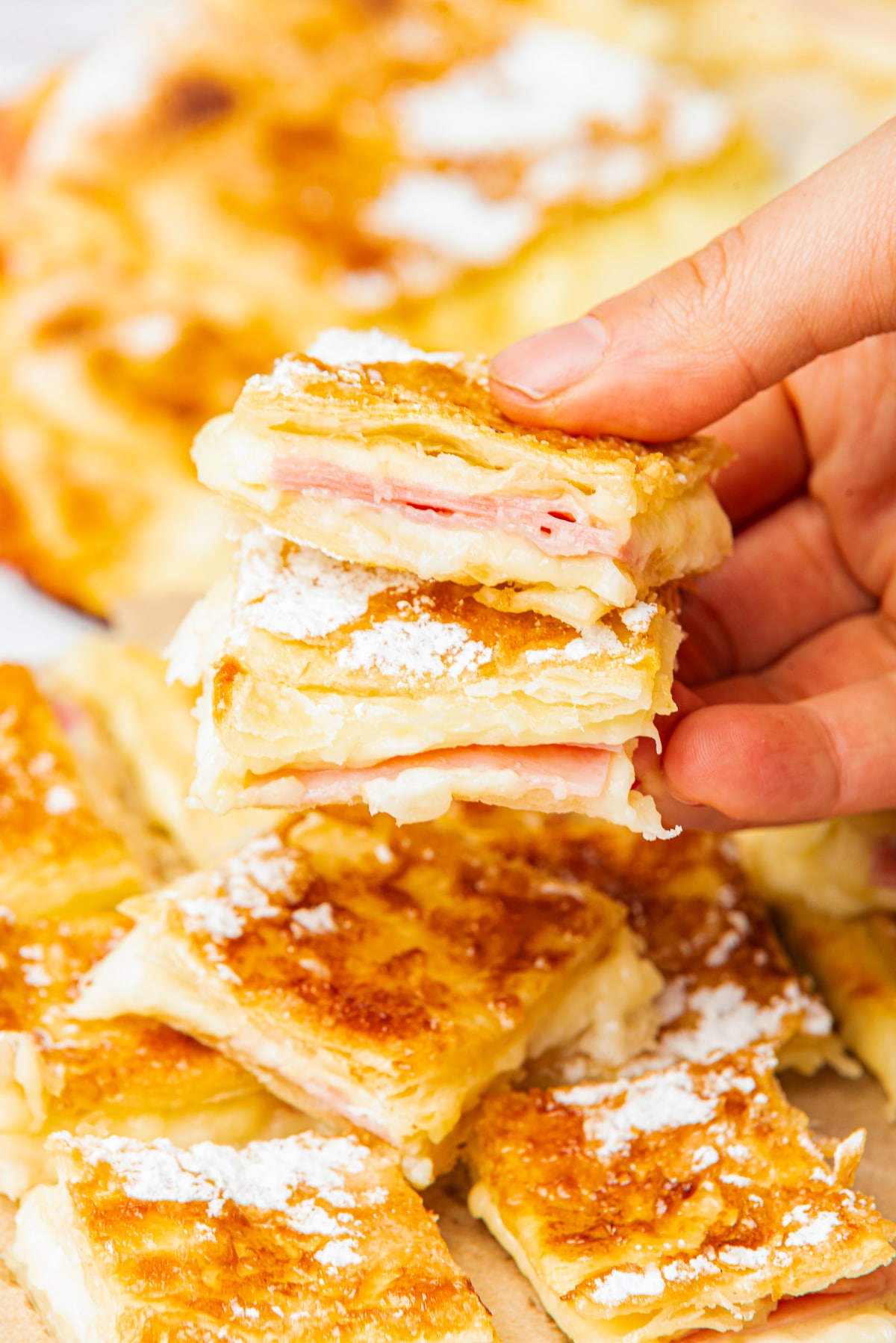 a hand holding up Ham Squares in air