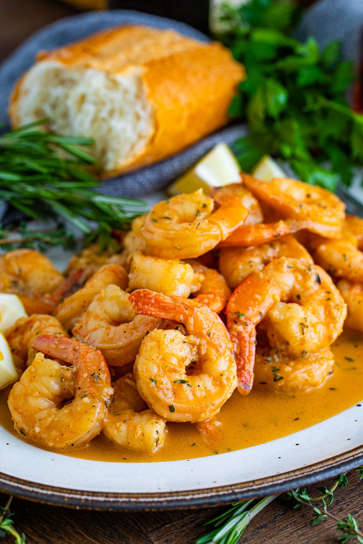 New Orleans BBQ Shrimp served on a white plate