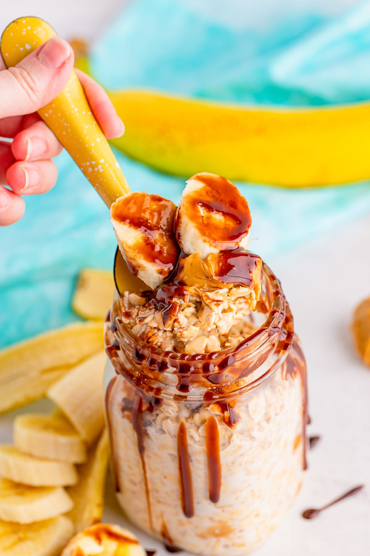 a spoon grabbing a bite of Peanut Butter Overnight Oats out of the jar