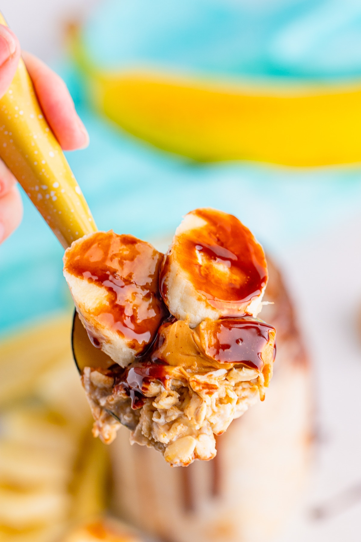 up close image of a spoon holding up a bite of Peanut Butter Overnight Oats in air