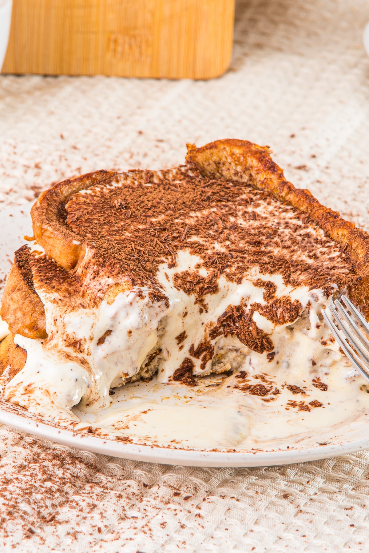 Tiramisu French Toast on a plate with bites taken out