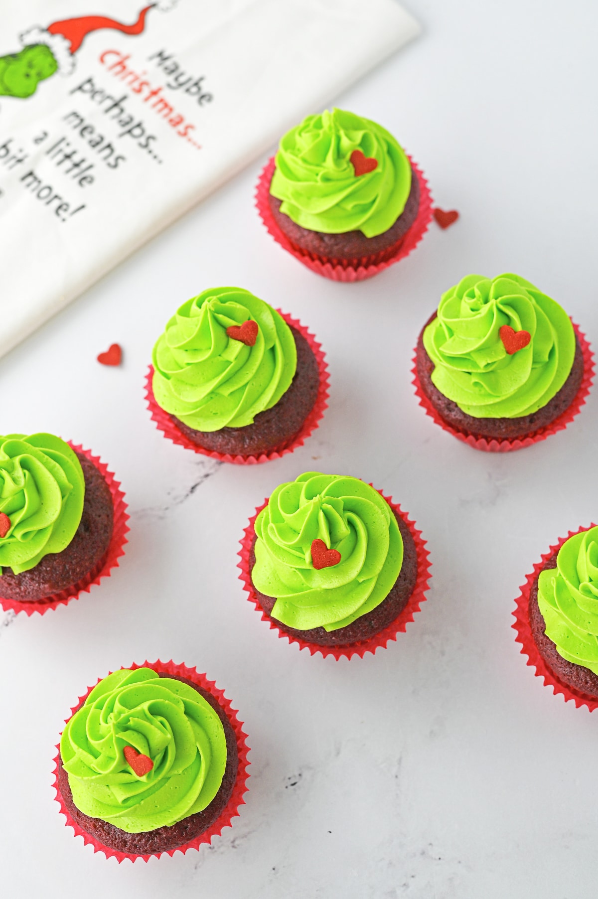 overhead image of Grinch Cupcakes on marble table top