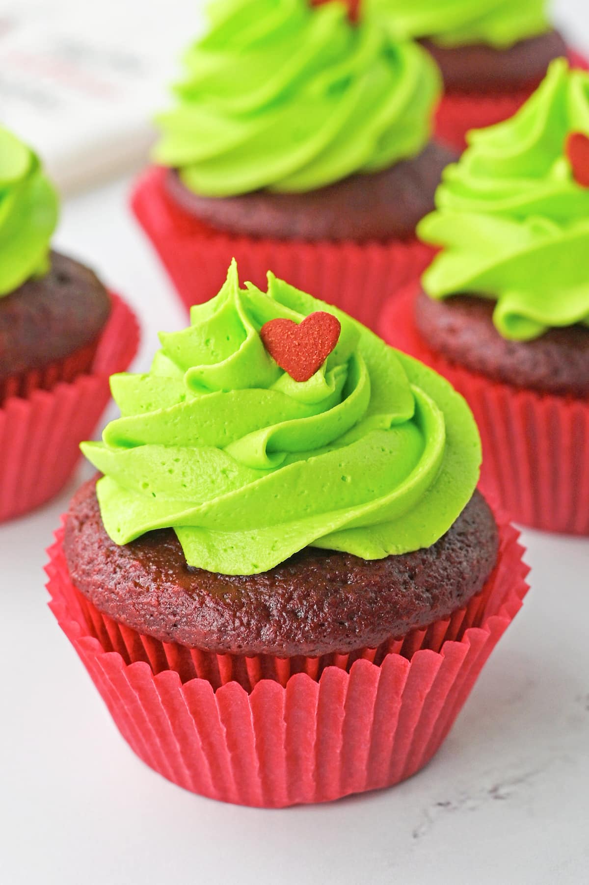 up close image of one Grinch Cupcakes with garnish