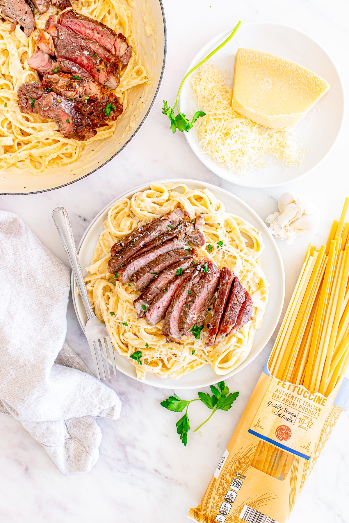 overhead image of portions of Steak Pasta Alfredo on plates
