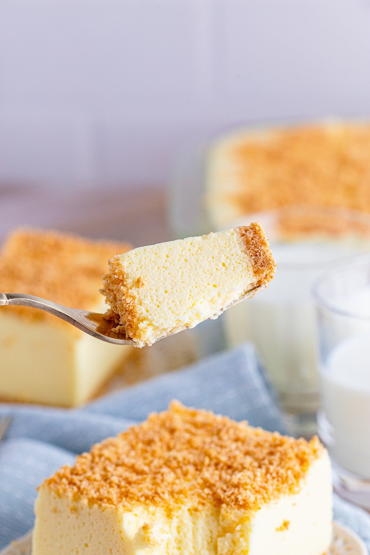 a fork holding up a bite of Woolworth Cake in air