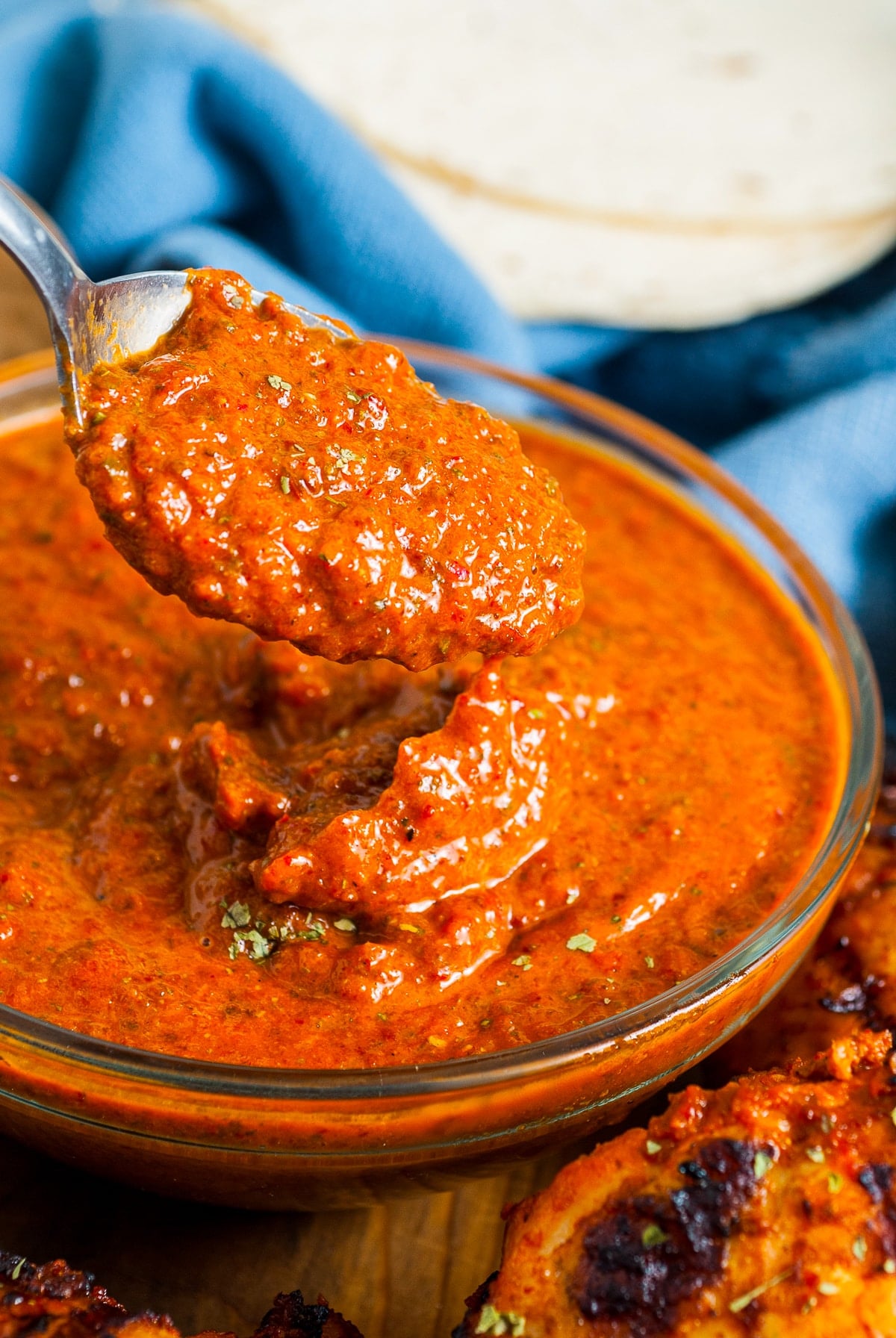 marinade for Chipotle Chicken Recipe in a glass bowl with a spoon over it