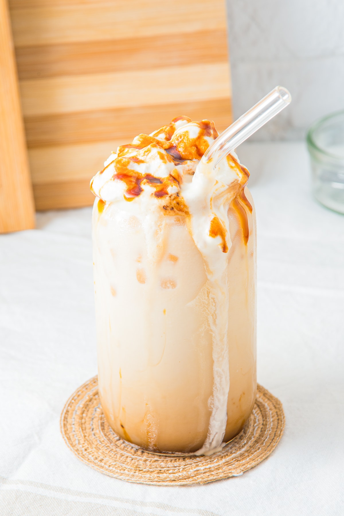 slightly overhead image of Iced Caramel Latte with whipped cream down the side