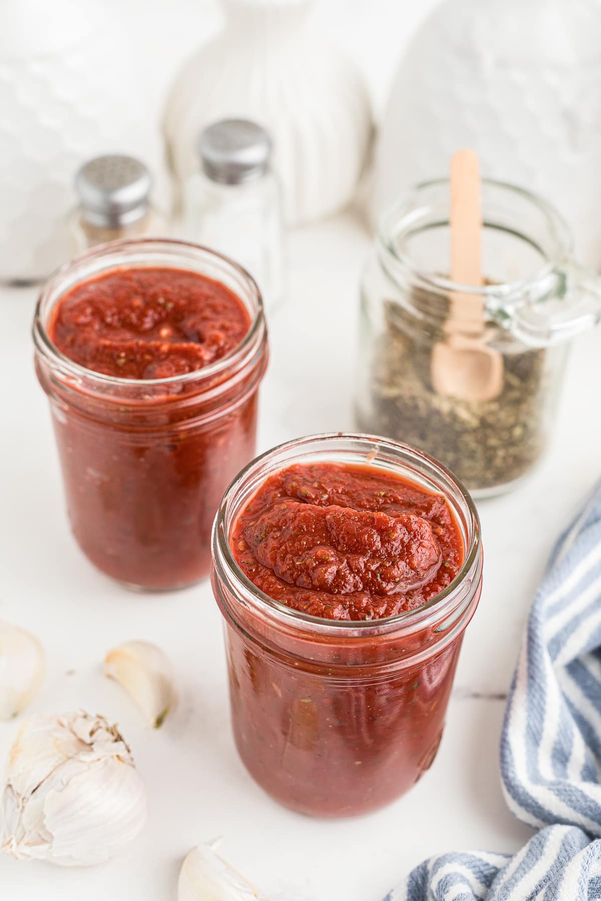 Pizza Sauce in two mason jars on white table