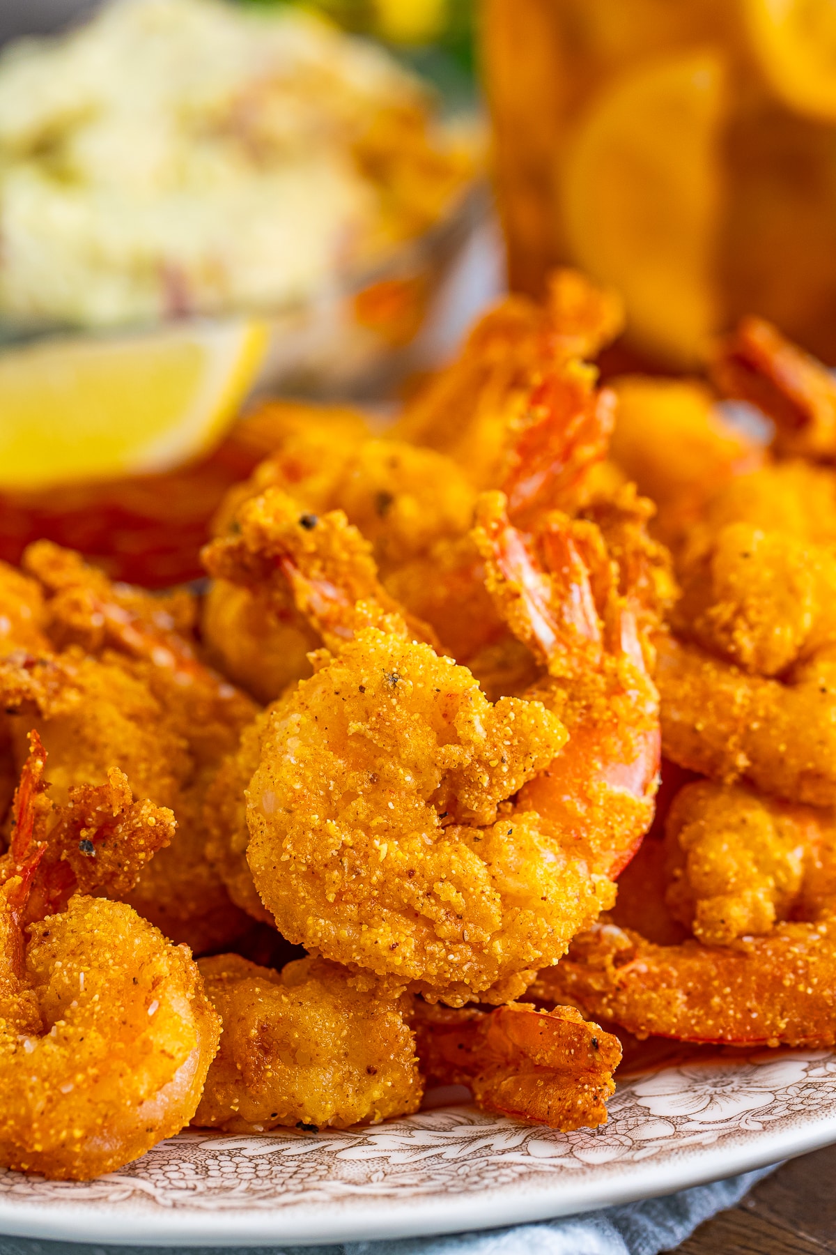 up close image of Fried Shrimp on a tan plate