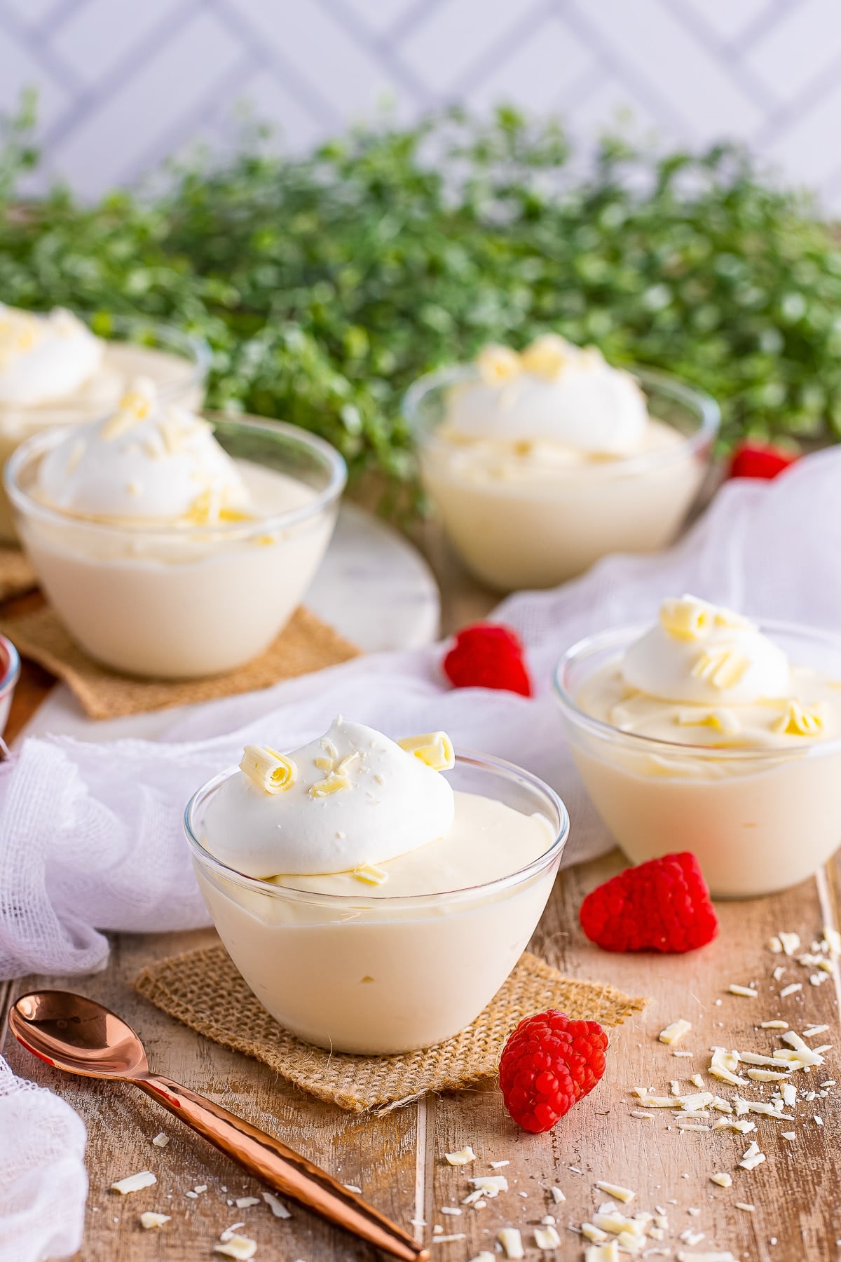White Chocolate Mousse in containers on a wooden table top