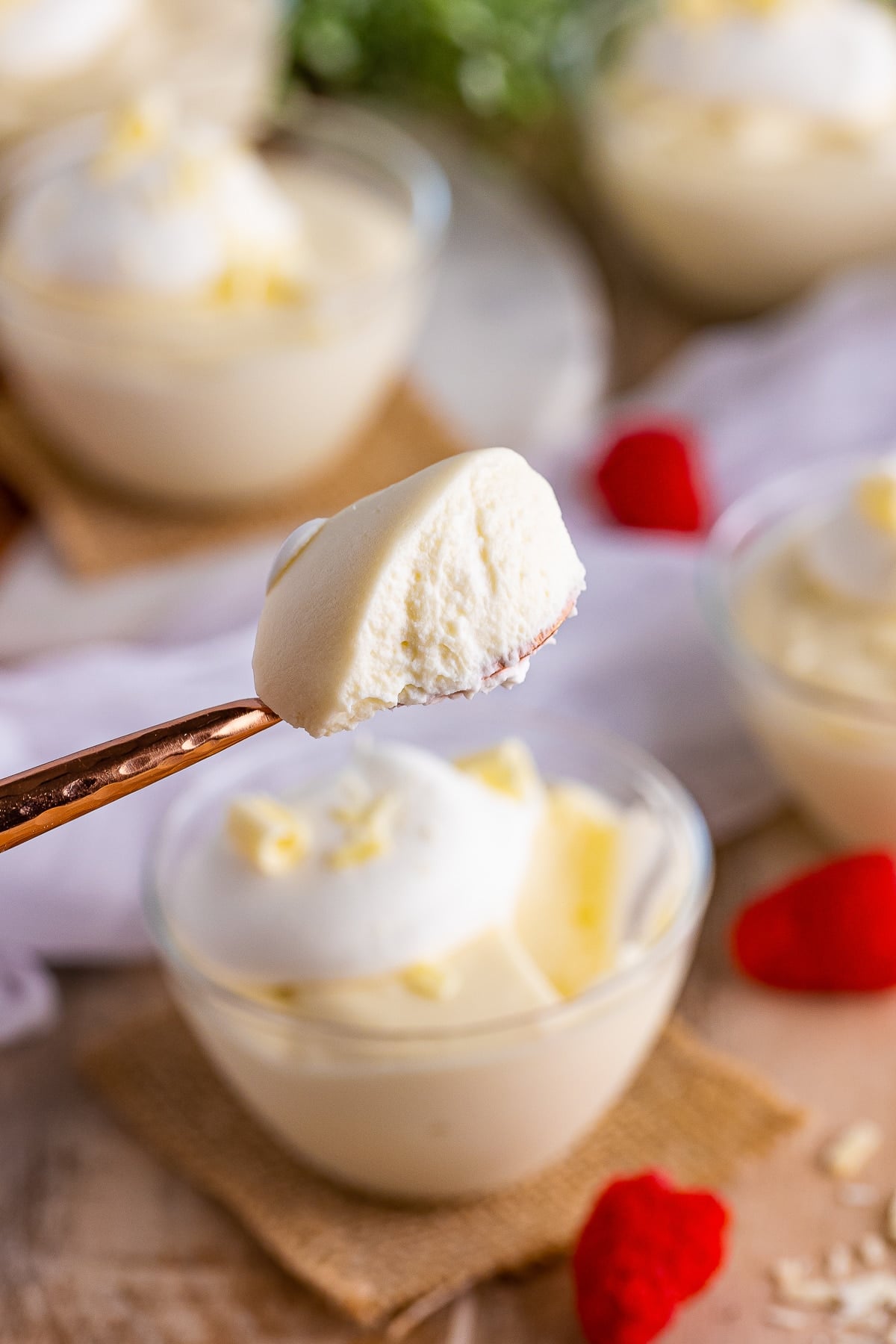 a spoon holding up a bite of White Chocolate Mousse in air