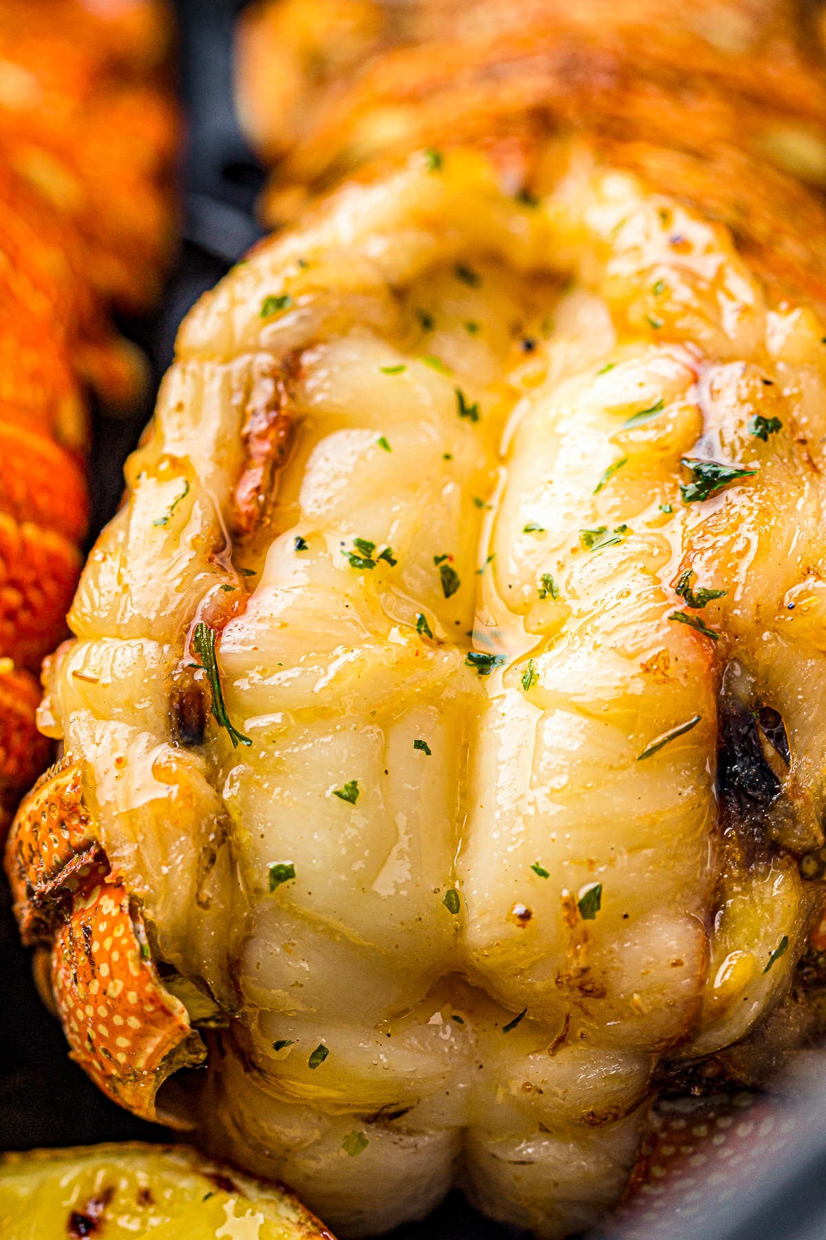 up close image of Air Fryer Lobster Tails with butter on top