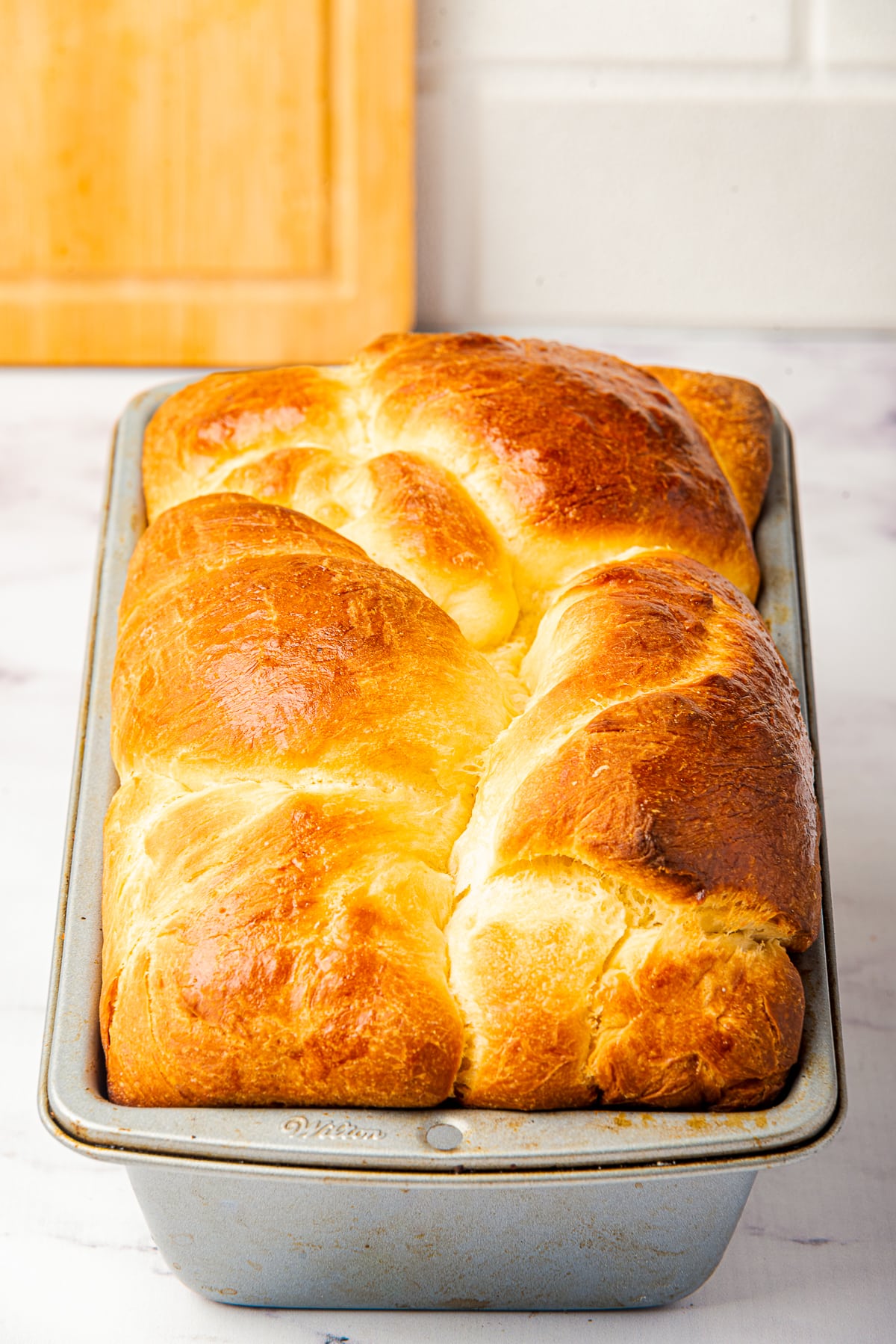 up close image of baked Brioche bread in loaf pan