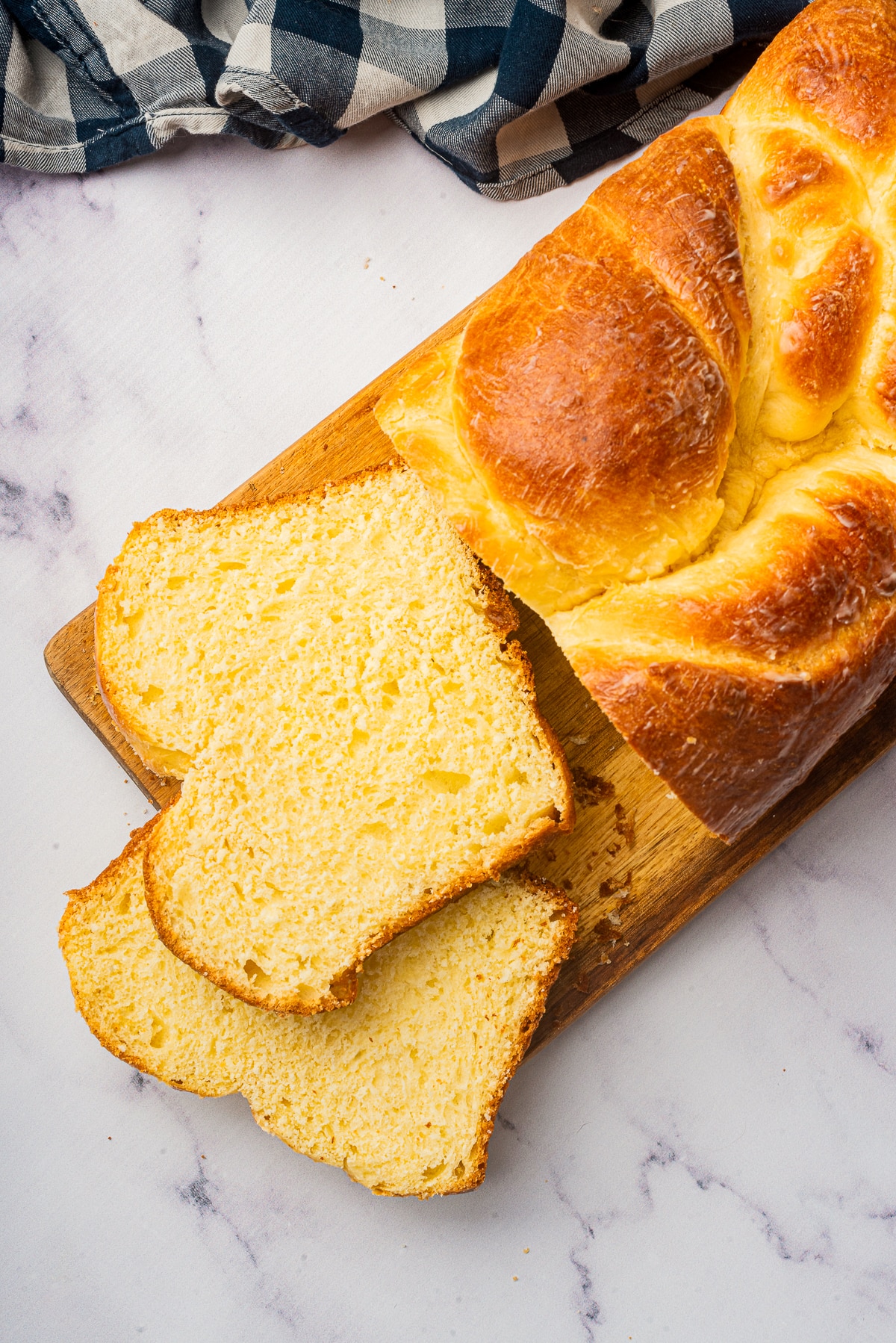 overhead image of sliced Brioche bread on wooden board