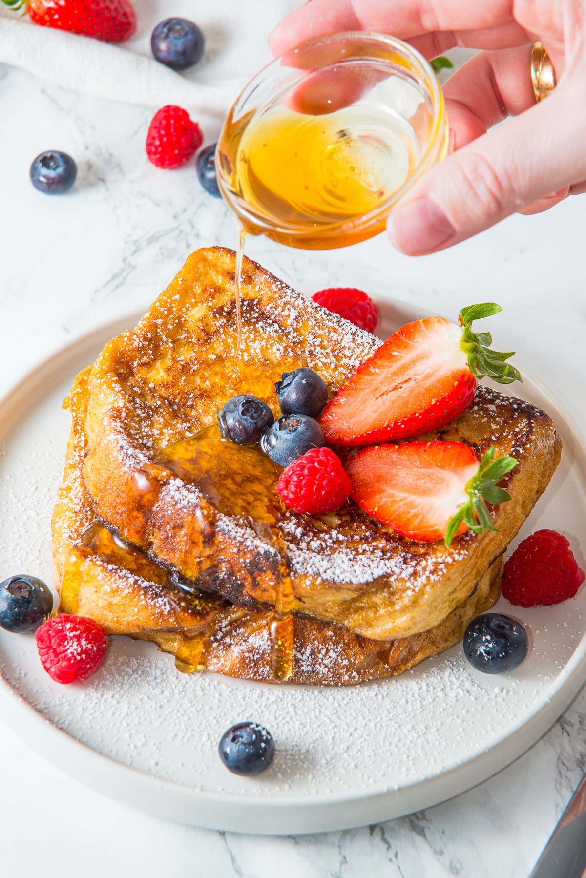 overhead image of maple syrup being poured on French toast recipe