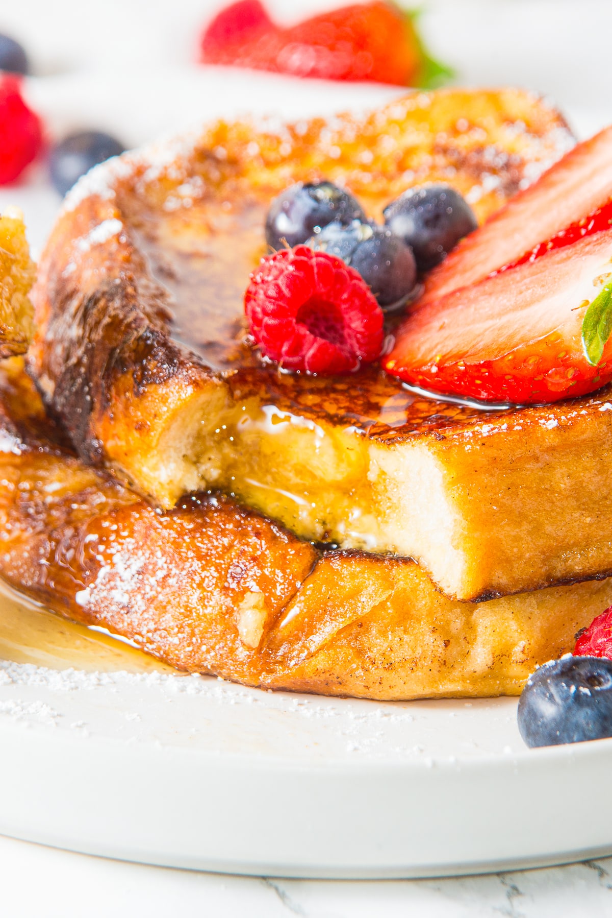 a bite taken out of a stack of French toast recipe