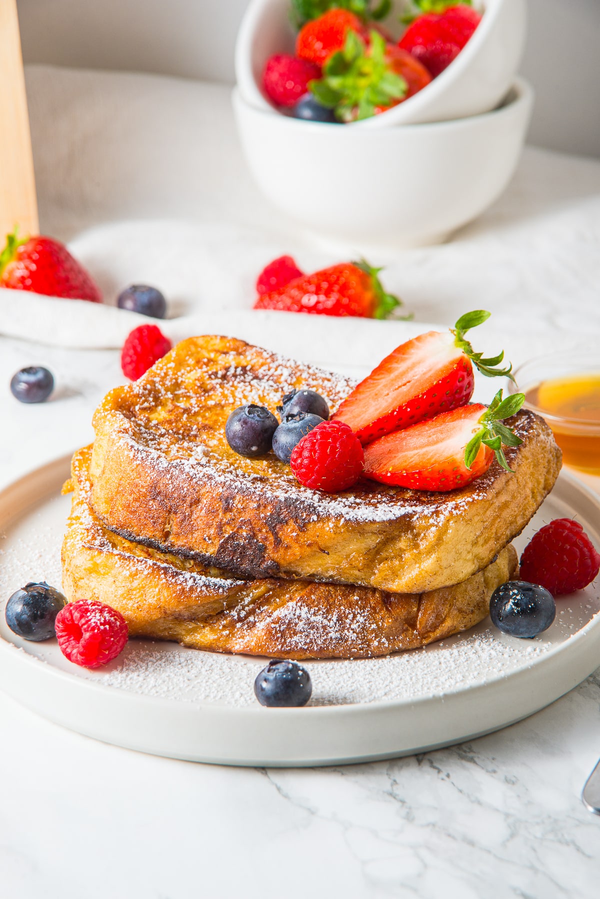 French toast recipe on a white plate with fruit