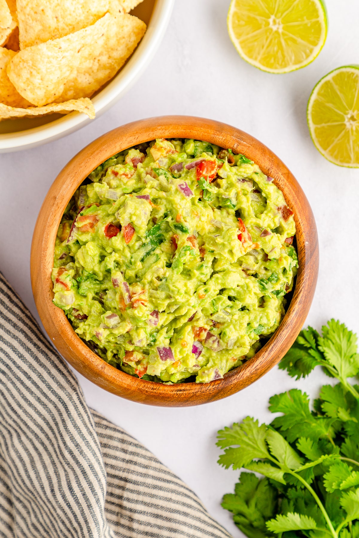overhead image of finished guacamole in wooden bowl