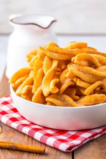 Copycat Taco Bell Cinnamon Twists Recipe piled in a serving bowl, golden puffed spirals coated in cinnamon sugar ready to serve as a copycat fast food dessert.