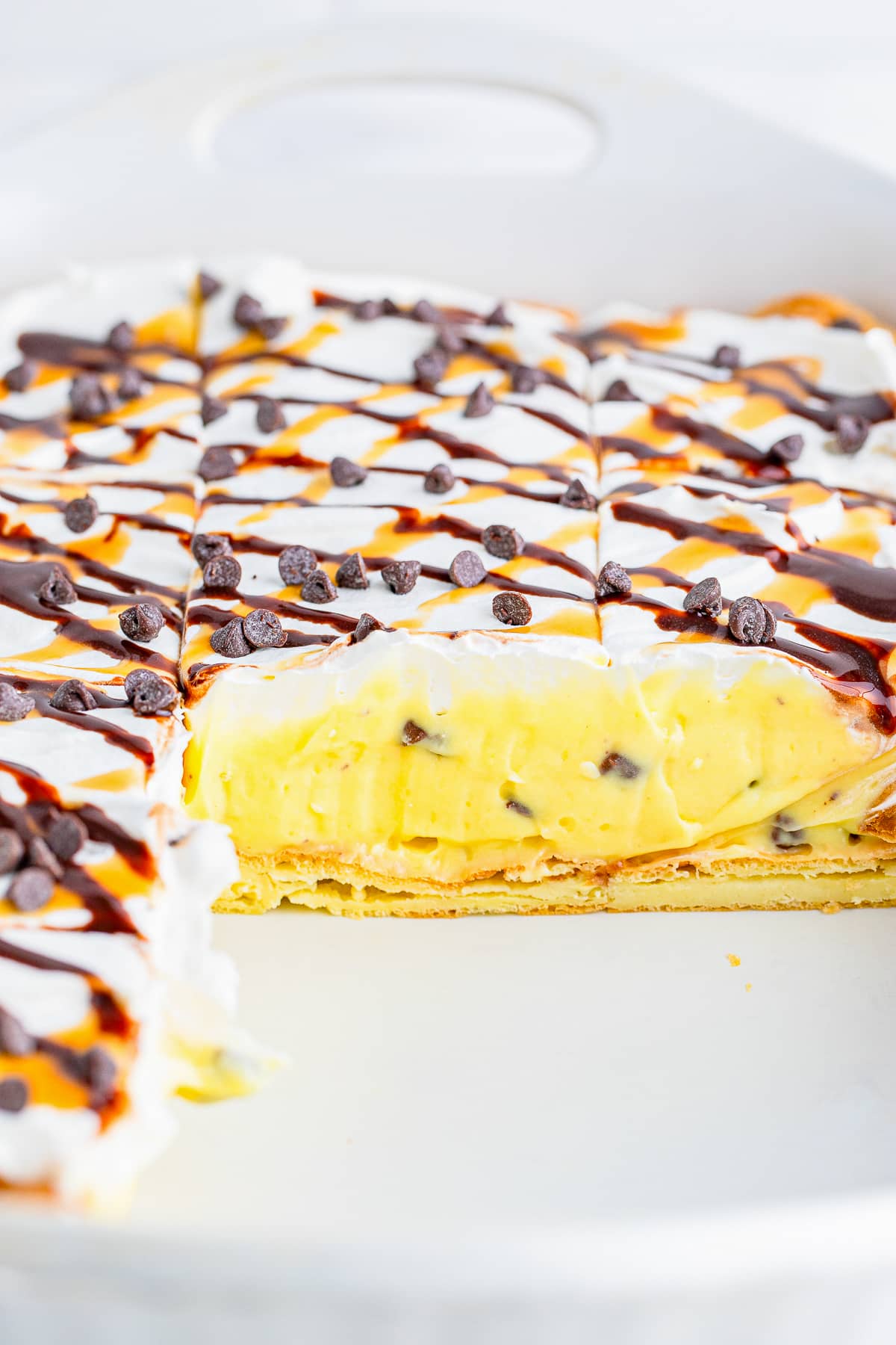 Cream Puff Cake in baking dish with slices taken out