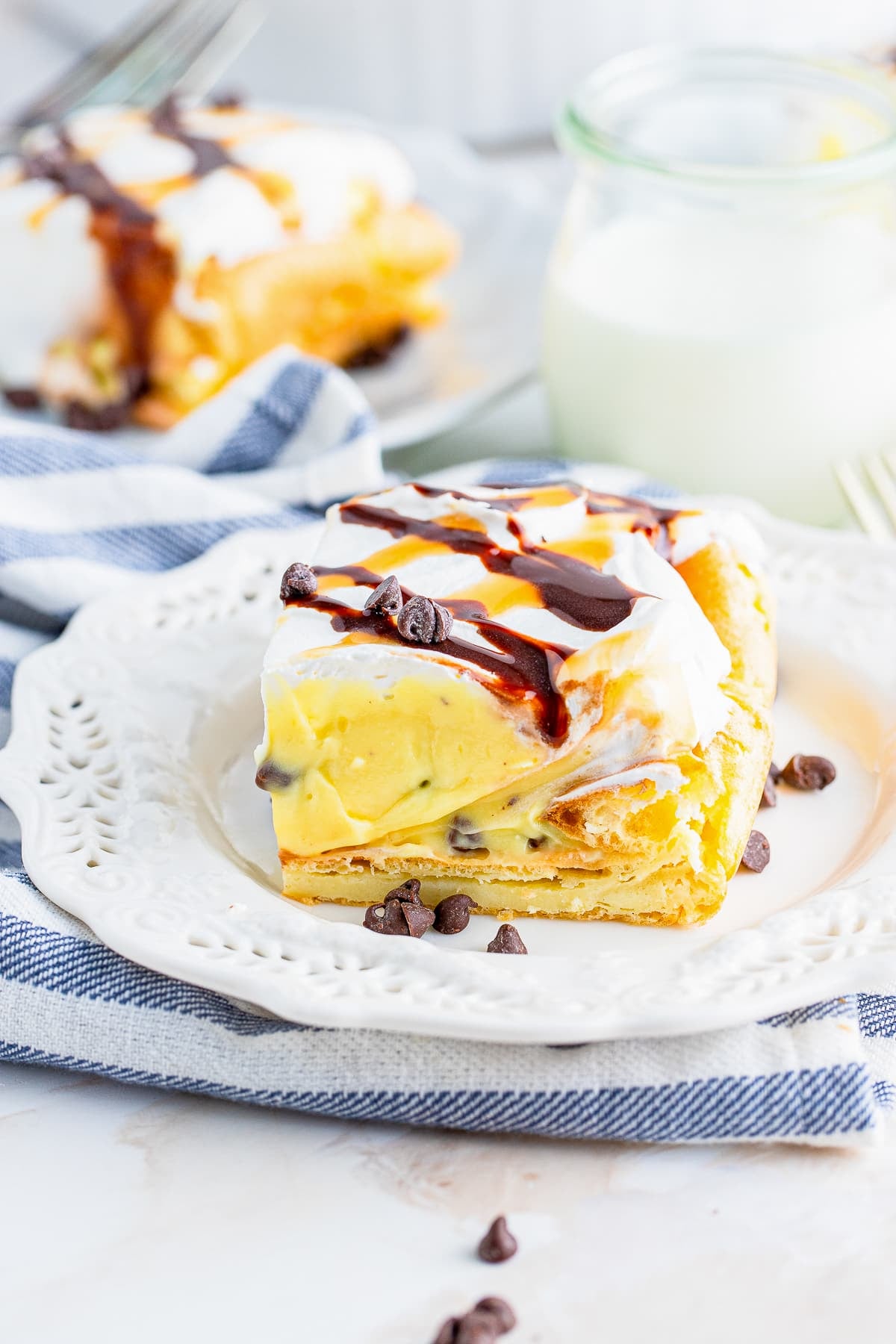 a slice of Cream Puff Cake on a white plate