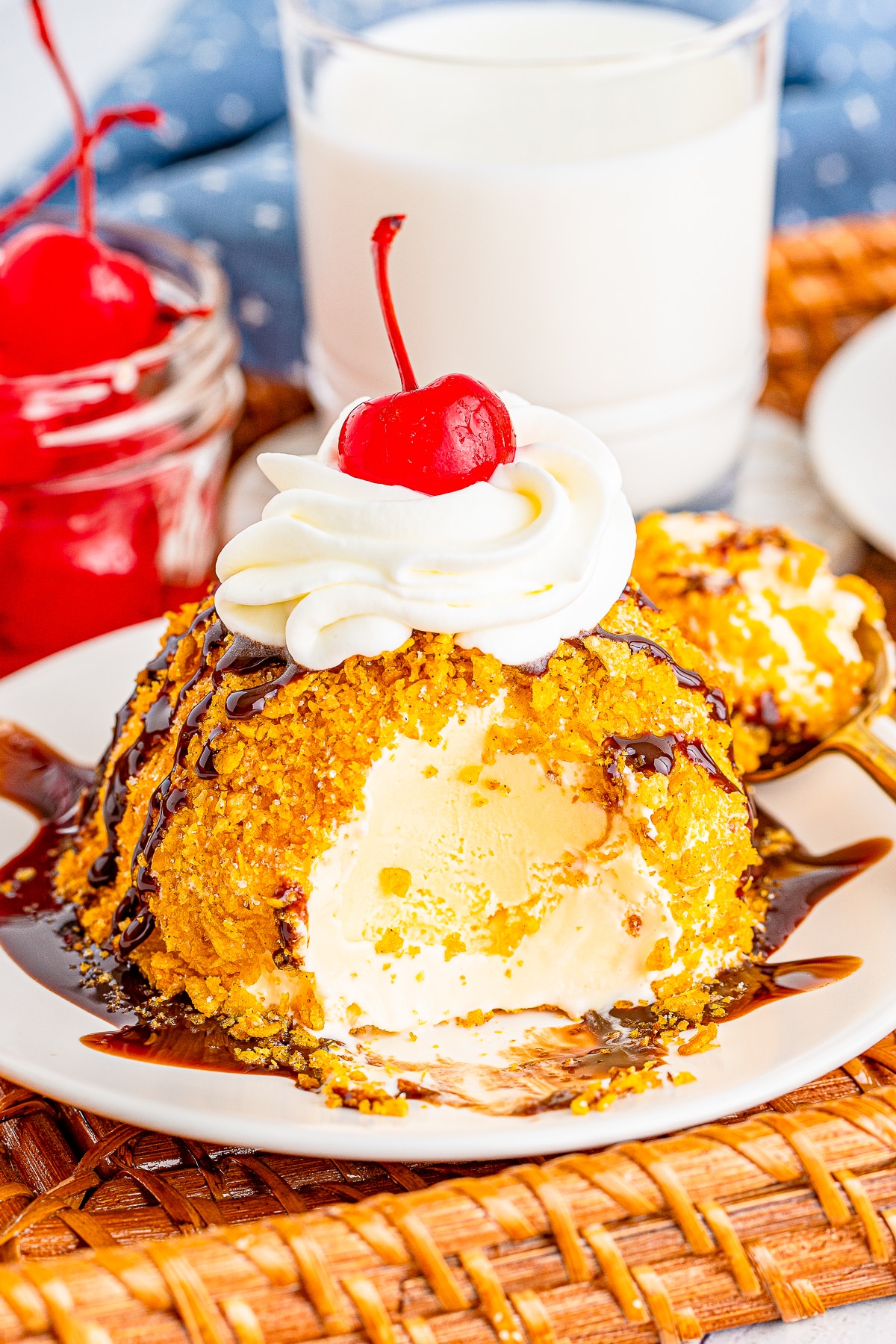 a ball of fried ice cream on a plate with a bite taken out