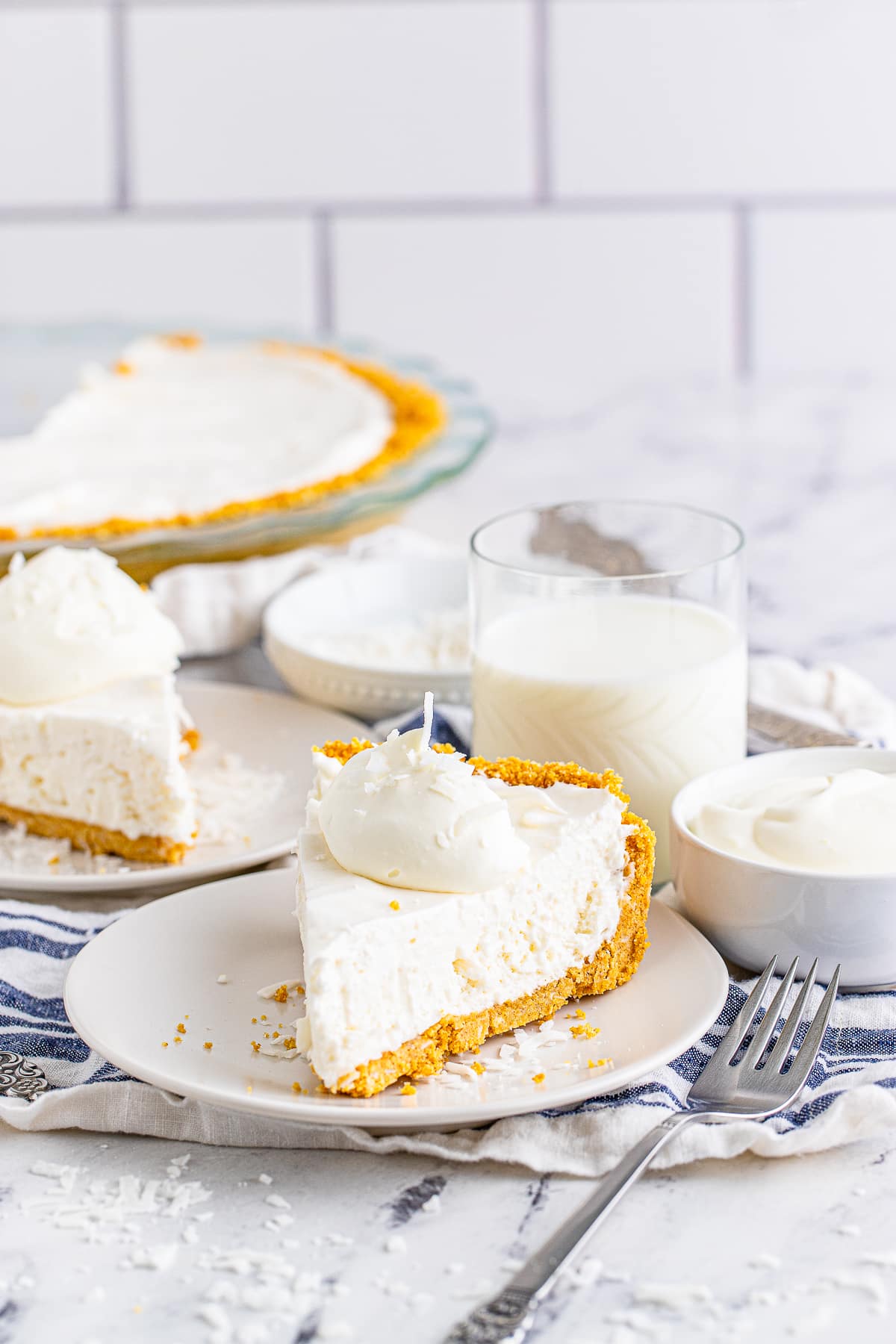 slices of coconut cream pie on white plates