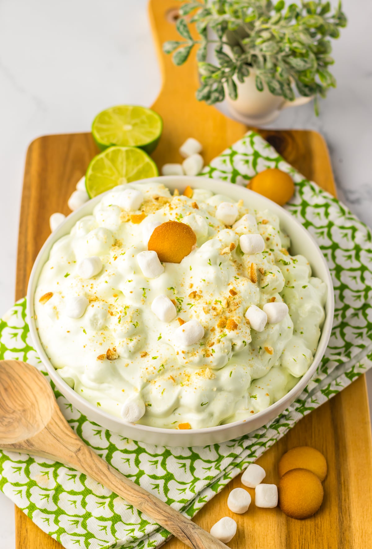 fluff salad served in a white bowl on wooden board