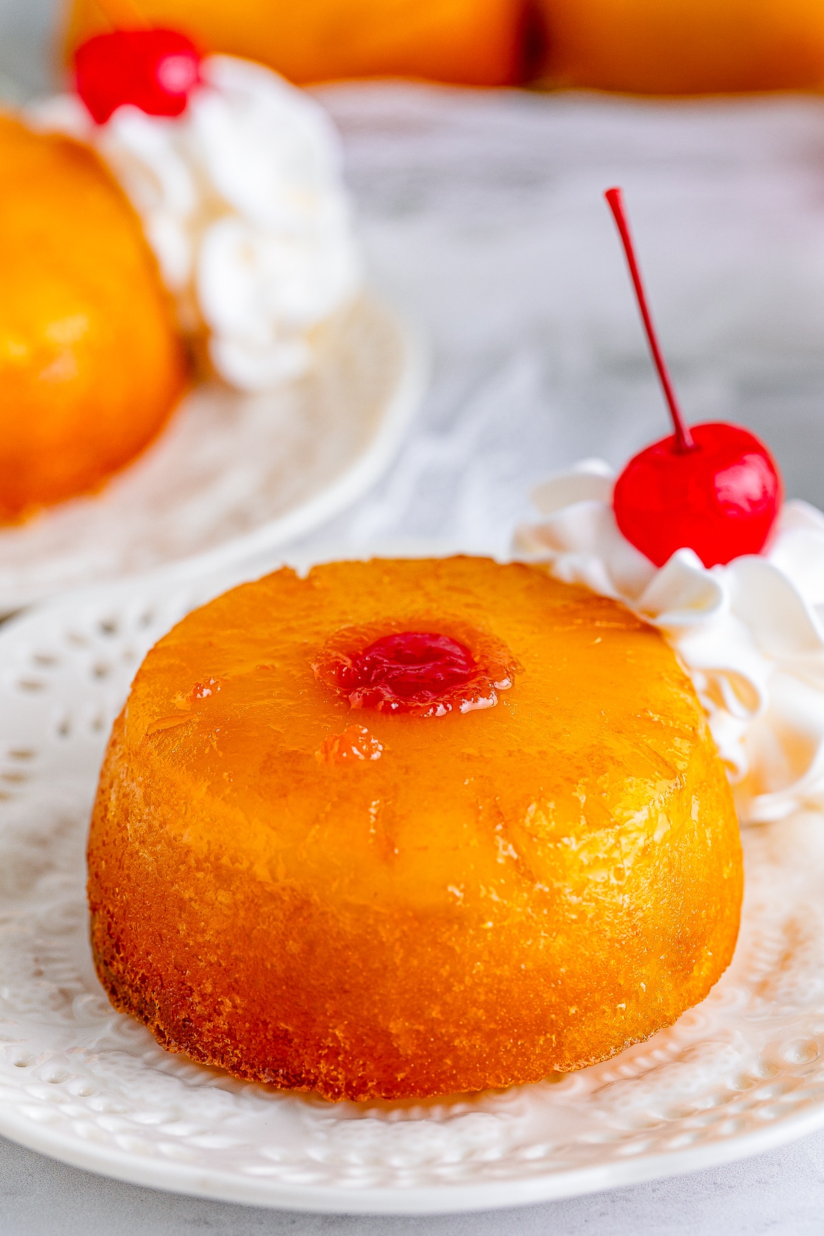 close up of Mini Pineapple Upside Down Cakes on white plate