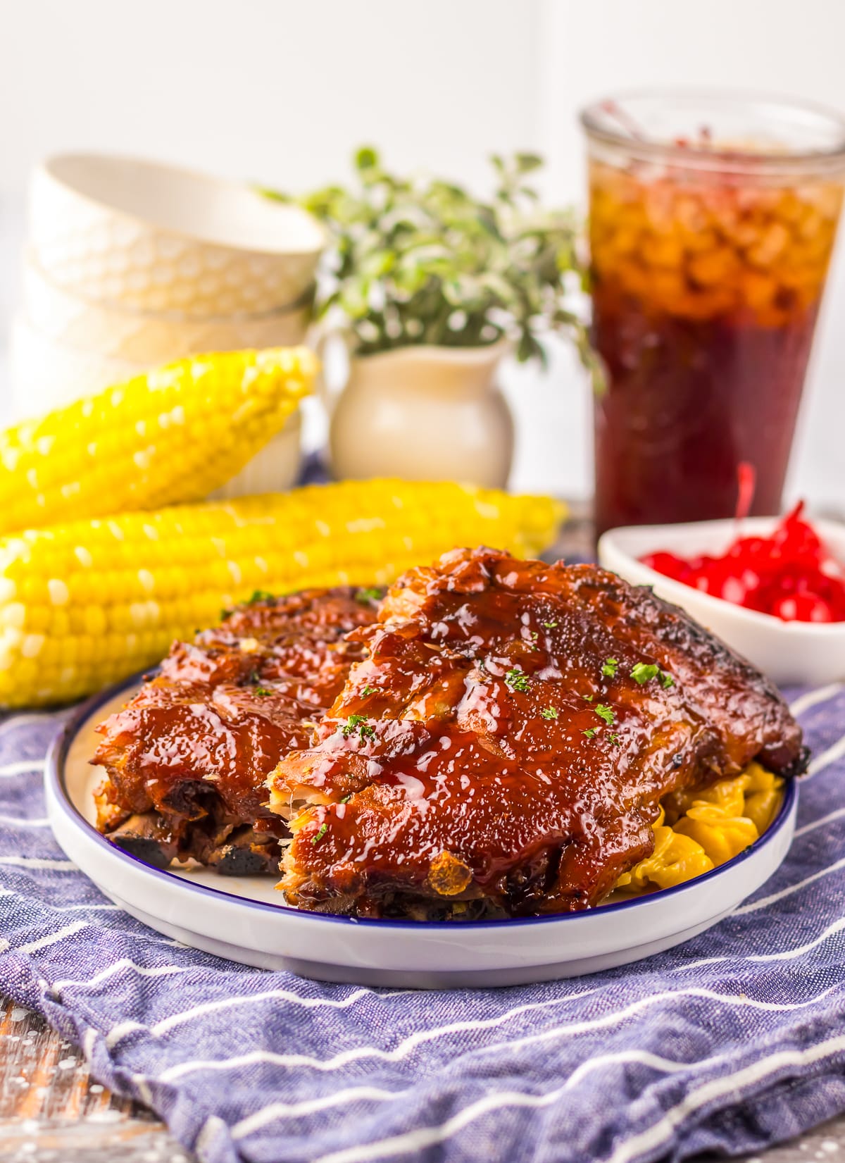 farther away image of Slow Cooker Barbecue Ribs with Coke on a white plate