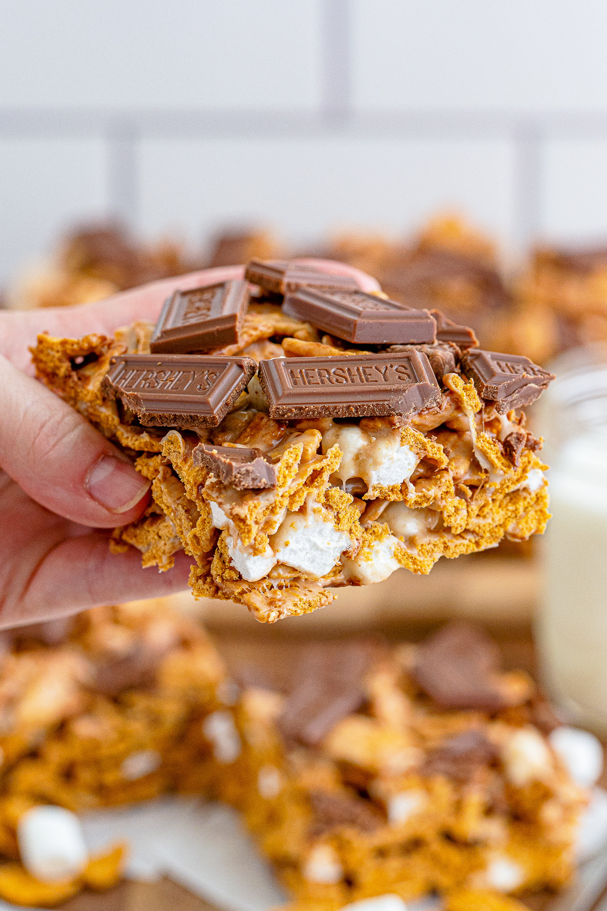a hand holding up Cereal Treats in air