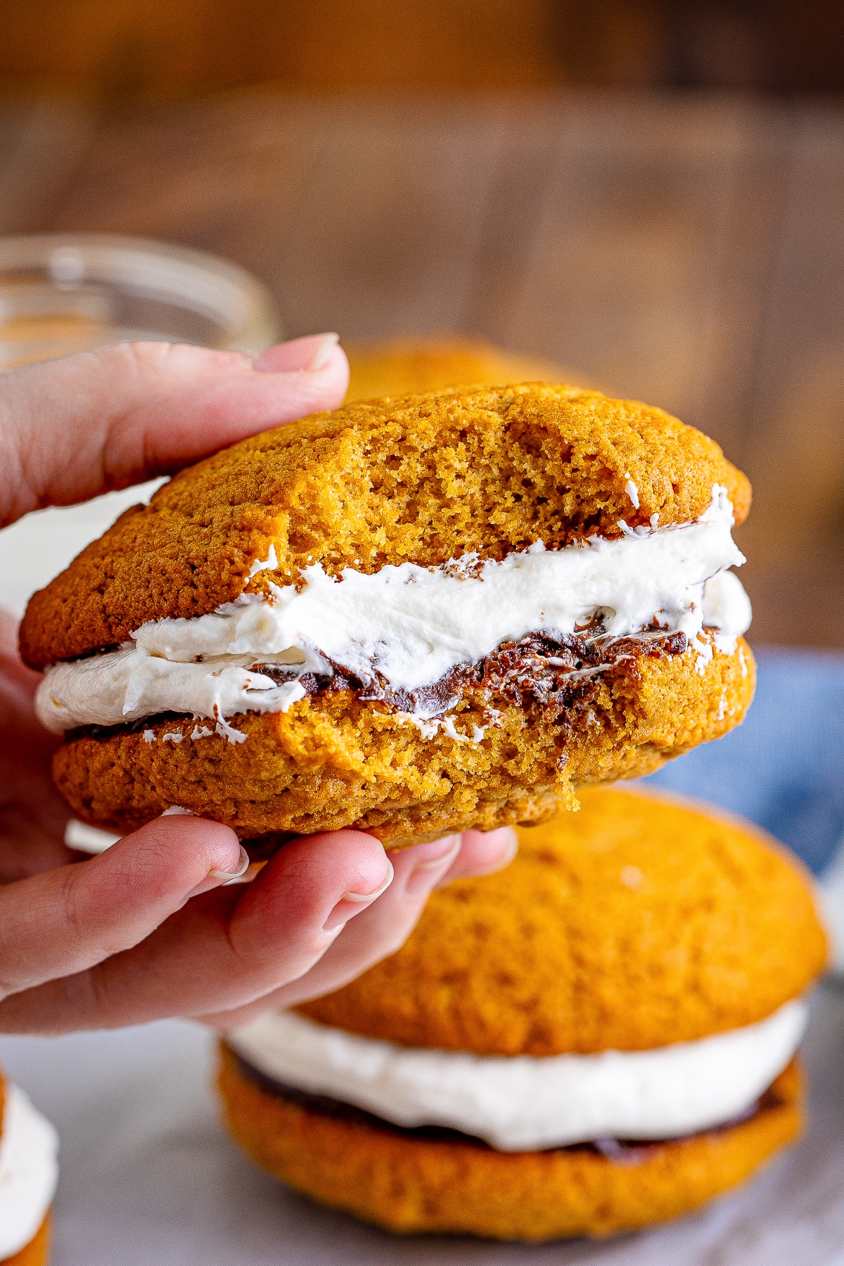 a hand holding up Whoopie Pies that has a bite taken out
