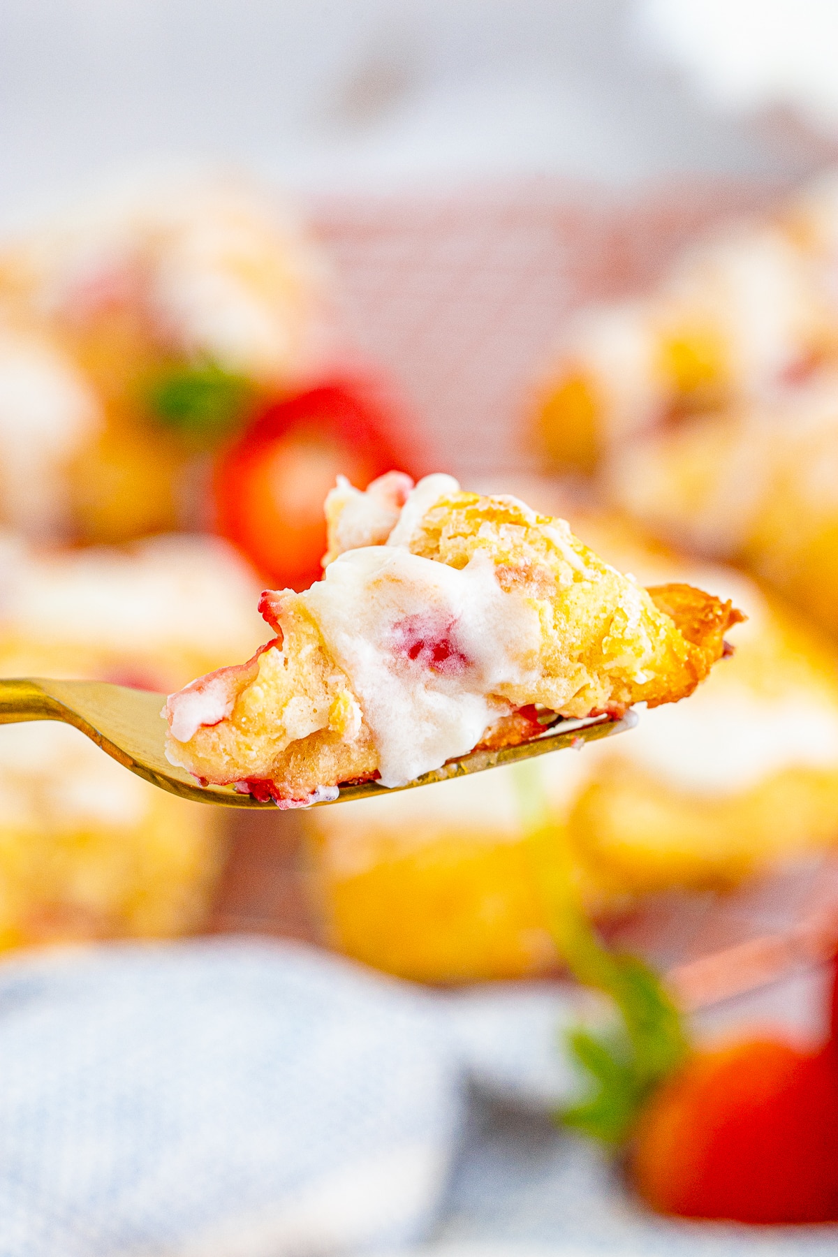 a fork holding up a bite of Strawberry Scones in air