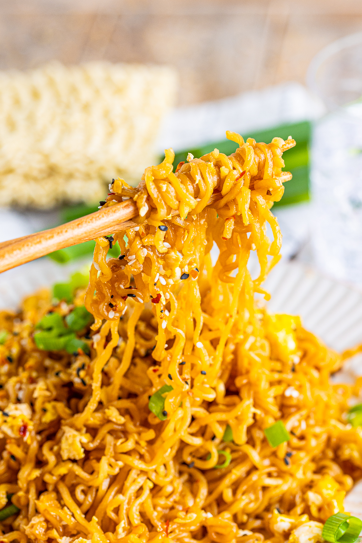 chopsticks holding up a bite of Tik Tok Ramen in air