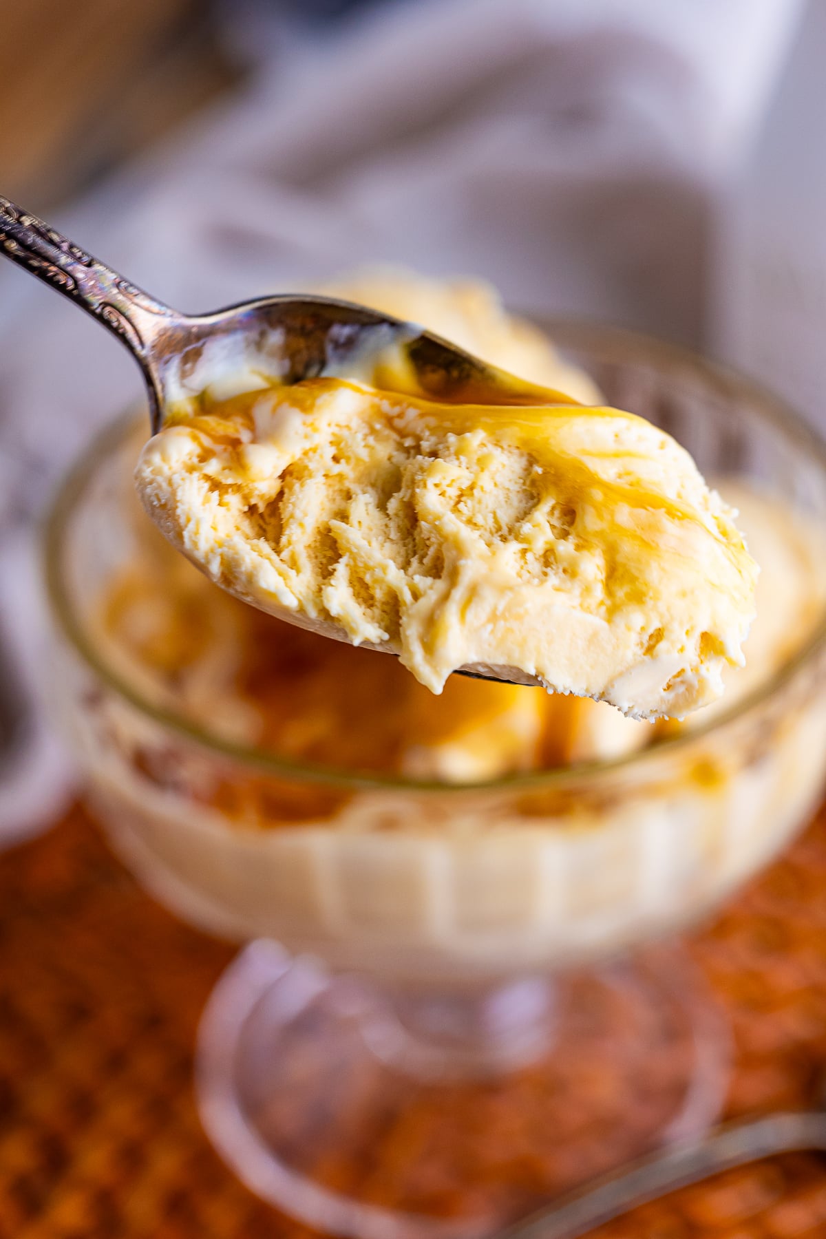 a spoon being held in the air with a bite of Butterscotch Ice Cream on it