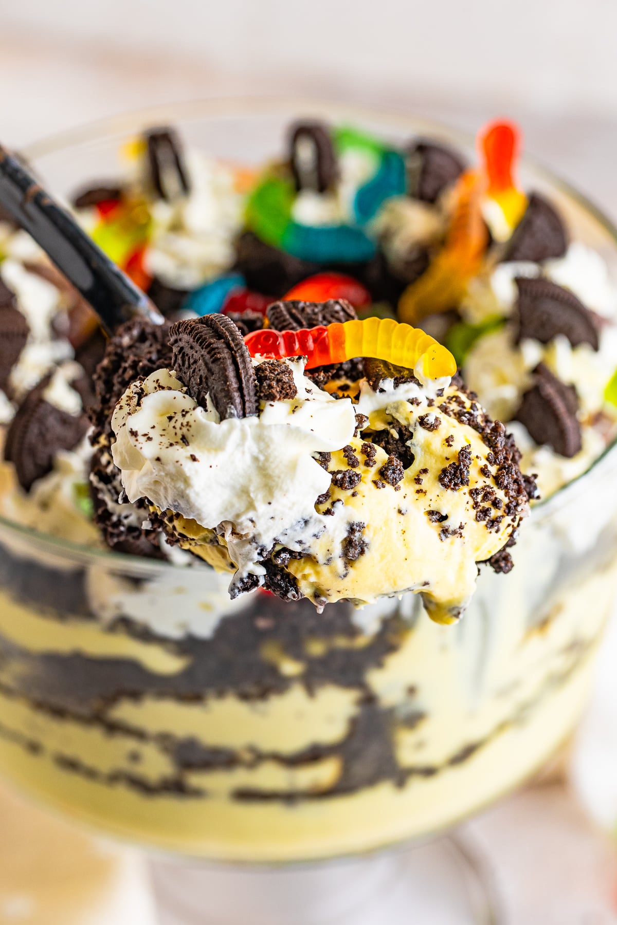 a spoon holding up a scoop of Dirt Cake Recipe in air
