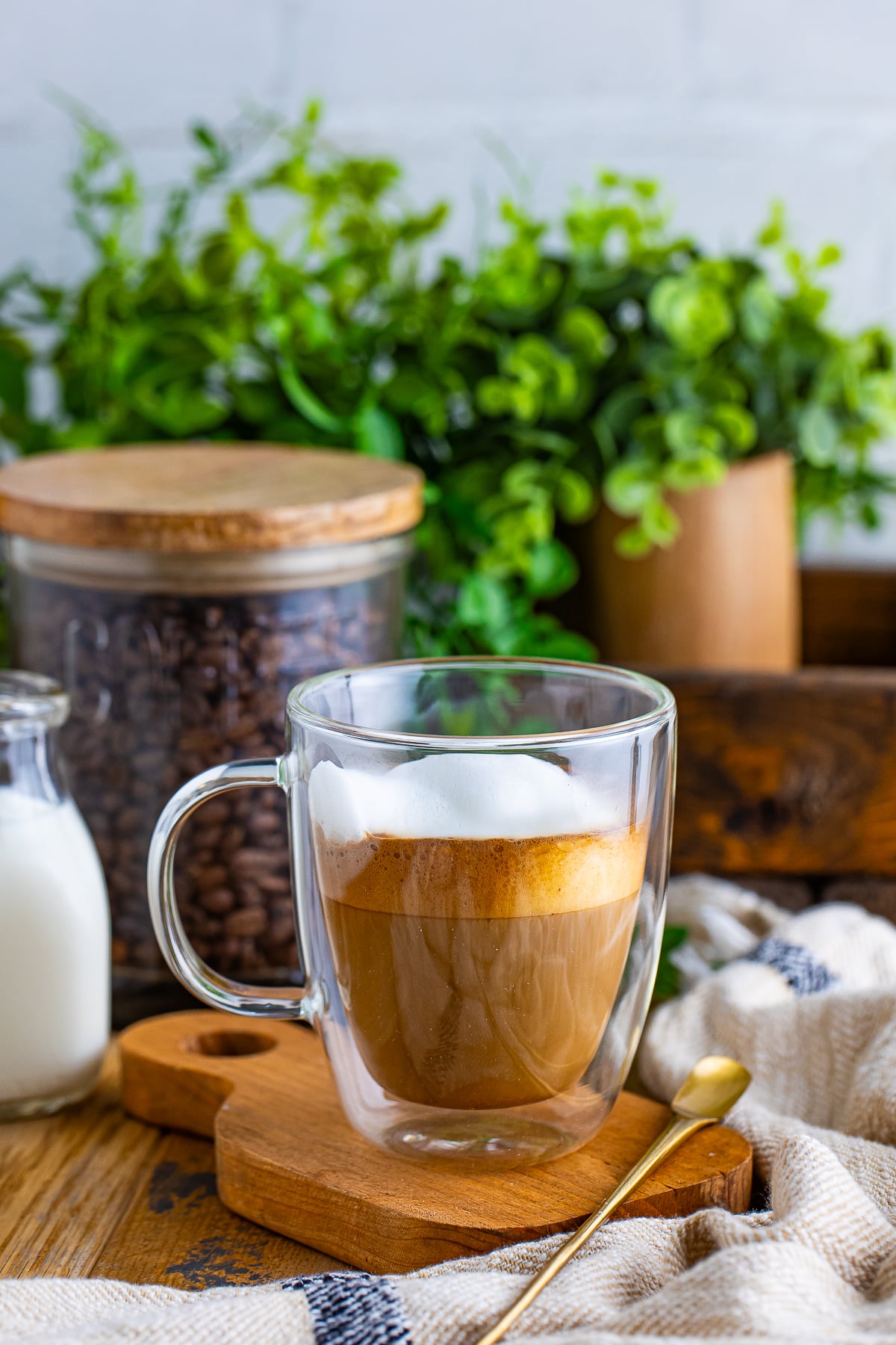 flat white in a mug on a small wooden board